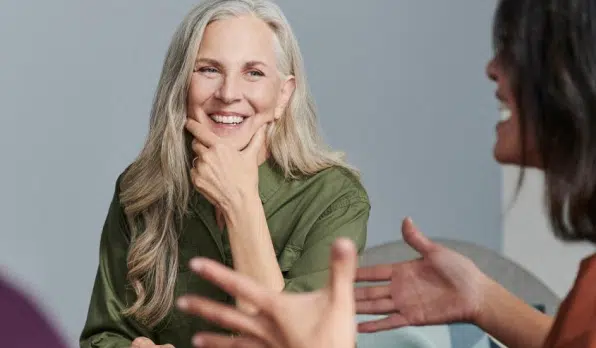 Woman smiling and interacting with her coworkers