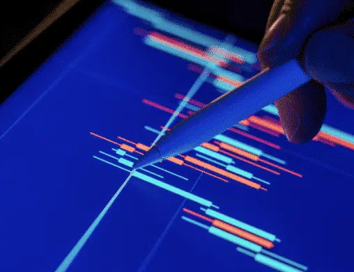 Person holding an apple pencil analyzing data on their tablet