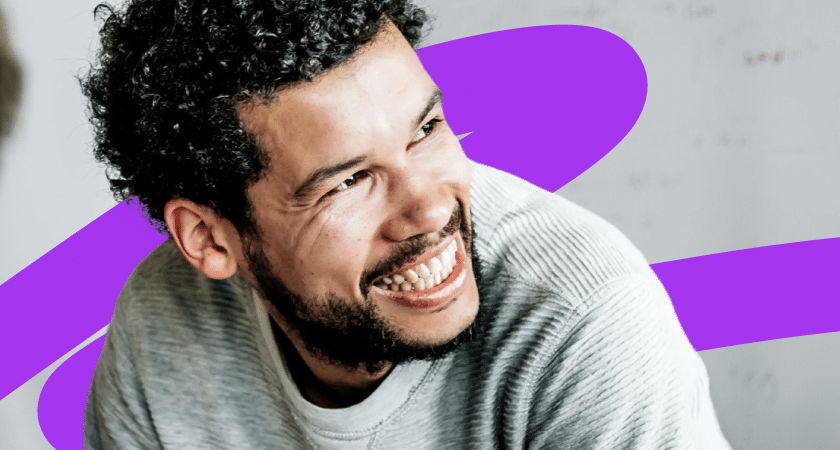 Man smiling and looking over his shoulder