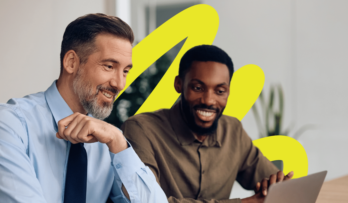 Two coworkers smiling and collaborating on a project