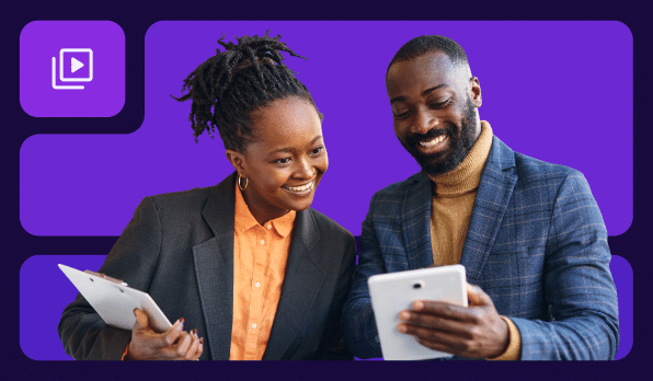 Two employees standing and reviewing data on their tablet