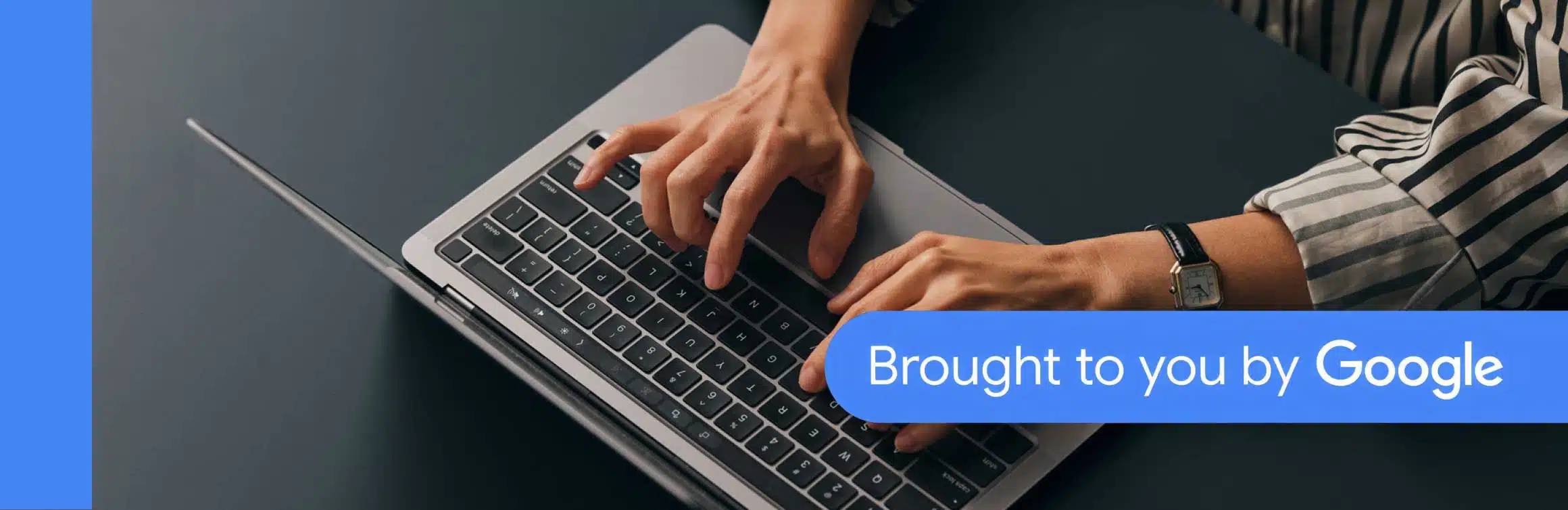 Hands typing on a laptop